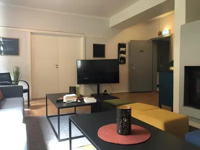 a living room with a flat screen tv and a couch at Birkelunden Bed & Breakfast in Rjukan