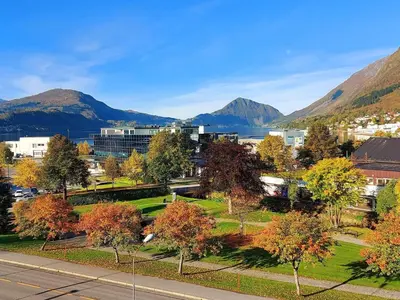 a view of a city with mountains in the background at Havila Hotel Ivar Aasen in Ørsta