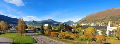 a city with mountains in the background at Havila Hotel Ivar Aasen in Ørsta