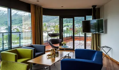 a room with chairs and a table and a large window at Havila Hotel Ivar Aasen in Ørsta