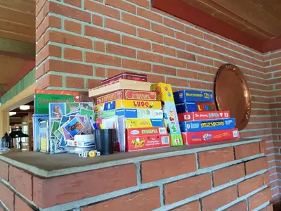 a shelf filled with books on a brick wall at Torsetlia in Dagali