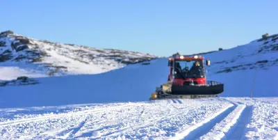a bulldozer on a snow covered hill with snow at Torsetlia in Dagali