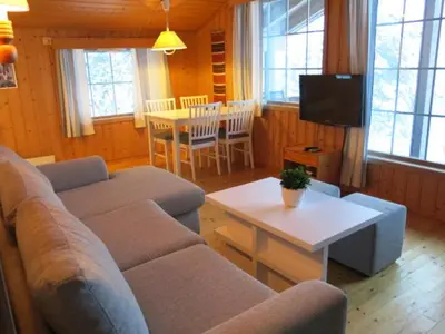 a living room with a couch and a table at Jølsterlia Hyttetun in Årdal