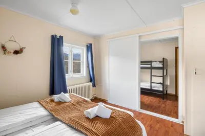 a bedroom with a bed with two pillows on it at Hardanger Guesthouse in Ulvik