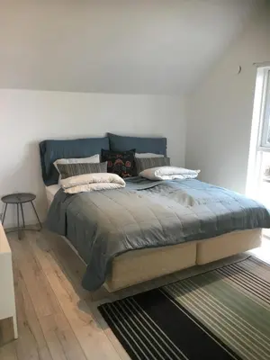 a bedroom with a large bed with pillows on it at Seaside Rentals in Trondheim