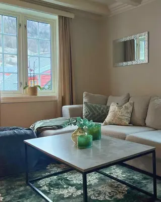 a living room with a coffee table and a couch at Stryn - house by the river in Stryn