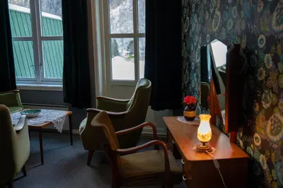 a room with a table and chairs and a window at Akrafjorden Nature B&B AS in Fjæra