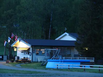 a building with flags in front of it at Birkelund camping in Geilo