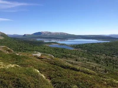 a view of a lake from the top of a mountain at Rondane Høyfjellshotell in Mysusæter