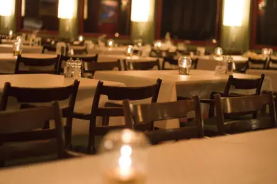 a room filled with tables and chairs with white tables and chairs at Rauland Høgfjellshotell in Rauland