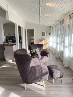 a living room with two chairs and a table at Vollsnes Feriehus in Hjelle