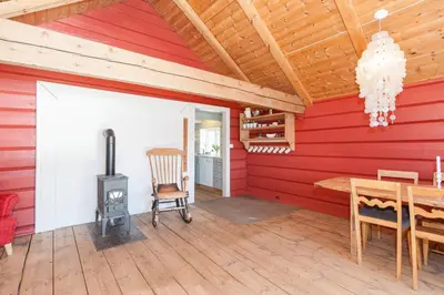 a dining room with a table and a wood stove at Bodvarstova in Stryn