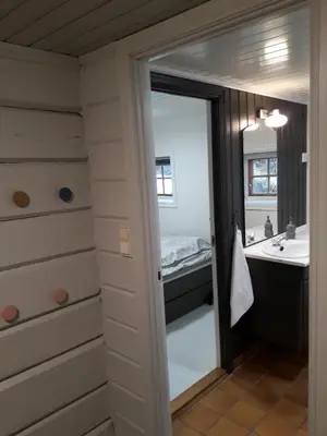 a bathroom with a sink and a mirror at Bodvarstova in Stryn