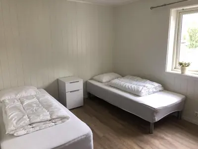 a room with two beds and a window at Åndalsnes gustehouse in Åndalsnes