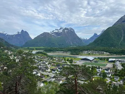 a town in a valley with mountains in the background at Åndalsnes gustehouse in Åndalsnes