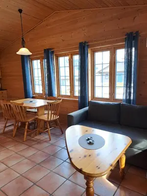 a living room with a couch and a table at Stardalen Hyttegrend in Klakegg