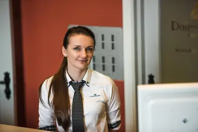a young woman wearing a shirt and a tie at Dolmsundet Hotell Hitra in Melandsjøen