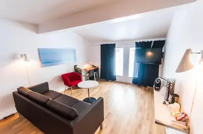 a living room with a couch and a table at Dolmsundet Hotell Hitra in Melandsjøen