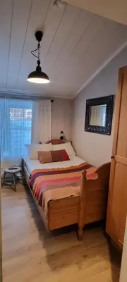a bedroom with a large bed in a room at Erzscheidergaarden Hotell in Røros