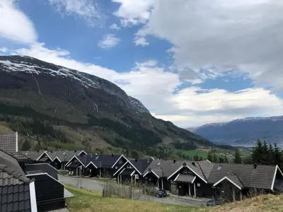 a row of houses in front of a mountain at Voss Hytte/Cabin in Skulestadmo