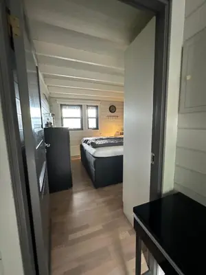 a small room with a bed in the middle of it at Voss Hytte/Cabin in Skulestadmo