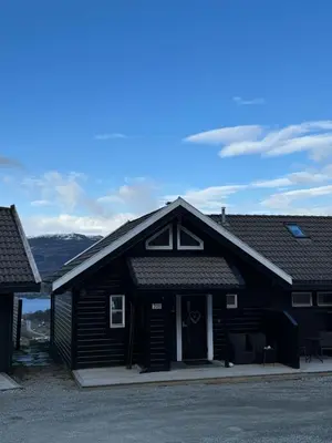 a large black building with a garage at Voss Hytte/Cabin in Skulestadmo