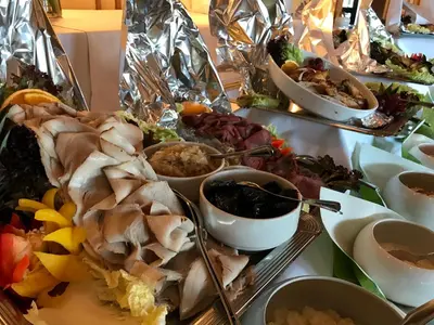 a table with a plate of food on a table at Alver Hotel in Alversund