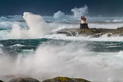 a lighthouse in the ocean with a large wave at Hotel Frøya in Sistranda