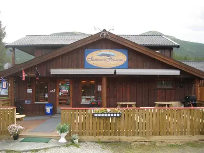a wooden building with a fence in front of it at Jotunheimen Feriesenter in Heidal