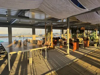 a patio with a table and chairs on a boat at P-Hotels Brattøra in Trondheim