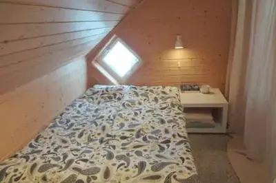 a bed in a small room with a window at Fully equipped flat, 2 bedrooms, FREE car parking. in Trondheim