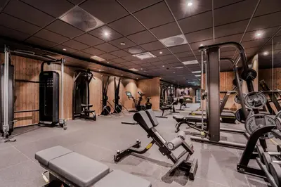 a gym with several treadmills and exercise bikes at Pellestova Hotell Hafjell in Hafjell