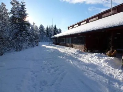 a snow covered road next to a building at Gjesteheim Havdal in Sundset