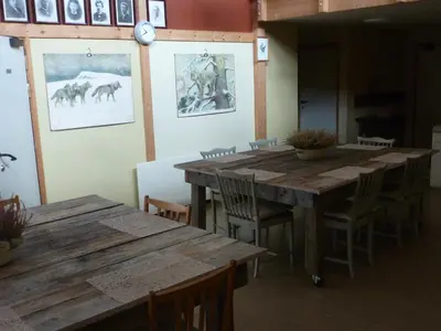a dining room with wooden tables and chairs at Gjesteheim Havdal in Sundset