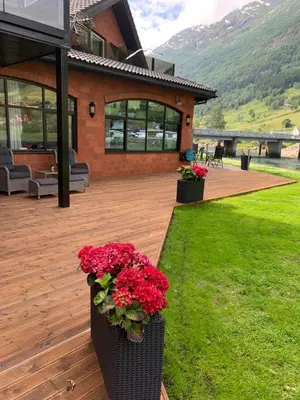a house with two vases filled with red flowers at Olden apartments 1 in Olden