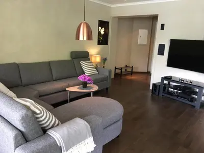 a living room with two couches and a flat screen tv at Olden apartments 1 in Olden
