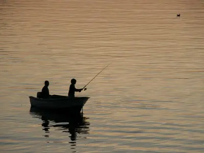 two men in a boat on the water fishing at 6 person holiday home in Åram-By Traum in Sandvik