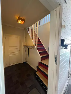 a staircase in a tiny house with a door at Kvam - Stegastein in Aurland