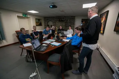 a group of people sitting around a table in a room at Kløver Hotel in Sauda