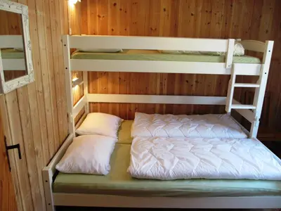 two bunk beds in a room with wooden walls at Hogstul Hytter - Knatten - 3 Bedroom Cottage in Tuddal