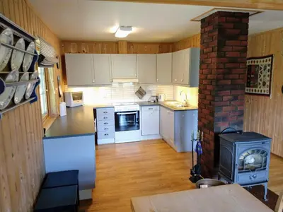a kitchen with white cabinets and a brick stove at Hogstul Hytter - Knatten - 3 Bedroom Cottage in Tuddal