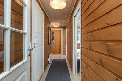 a hallway of a house with wooden walls and a door at Nordseter Apartments in Lillehammer