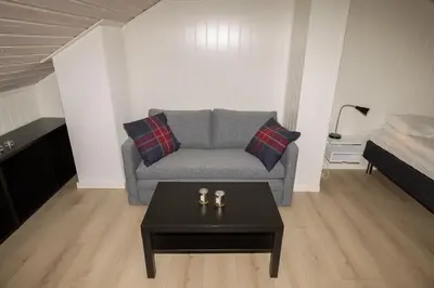 a living room with a couch and a coffee table at Nordseter Apartments in Lillehammer