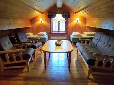 a room with couches and a table in a room at Hogstul Hytter - Gamlestua in Tuddal