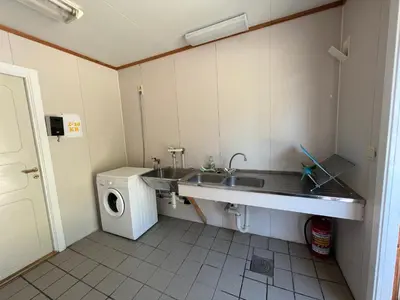 a bathroom with a sink and a washing machine at Vistdal Camping in Myklebostad