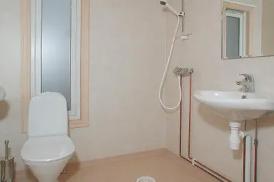 a bathroom with a shower and a toilet and a sink at Hedmarktoppen in Hamar