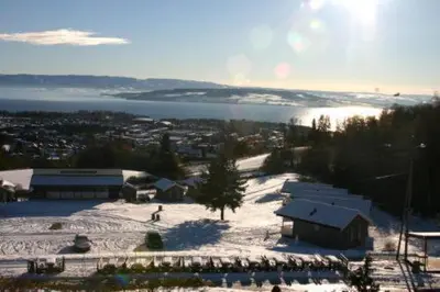 a person is skiing down a snow covered slope at Hedmarktoppen in Hamar