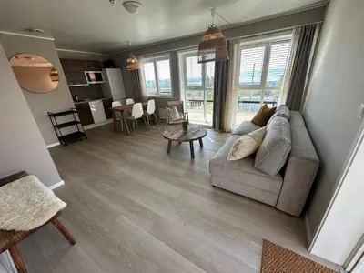 a living room with a couch and a table at Hedmarktoppen in Hamar
