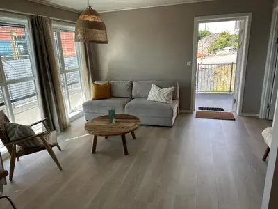 a living room with a couch and a table at Hedmarktoppen in Hamar