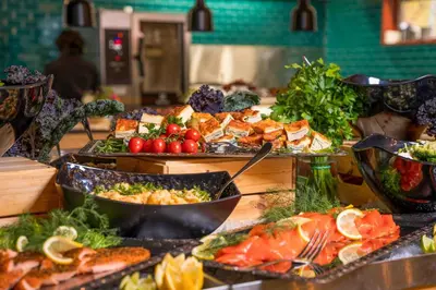 a buffet with many different types of food on a table at Thorbjørnrud Hotell in Jevnaker